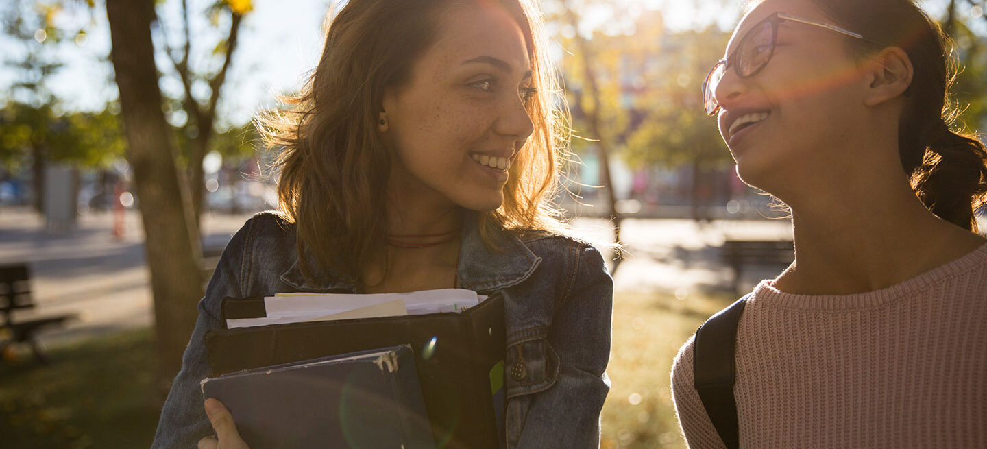 Two People Walking with Books