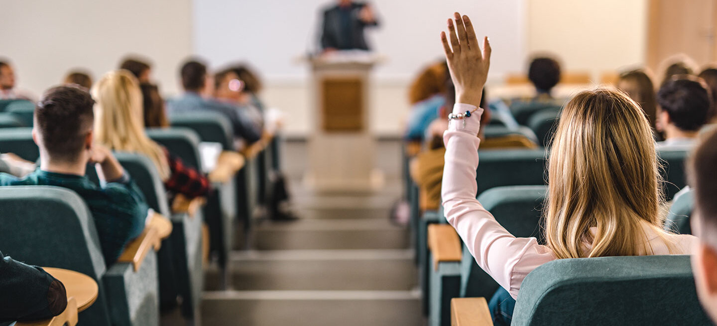 Female Teen Raising Handing During Lecture
