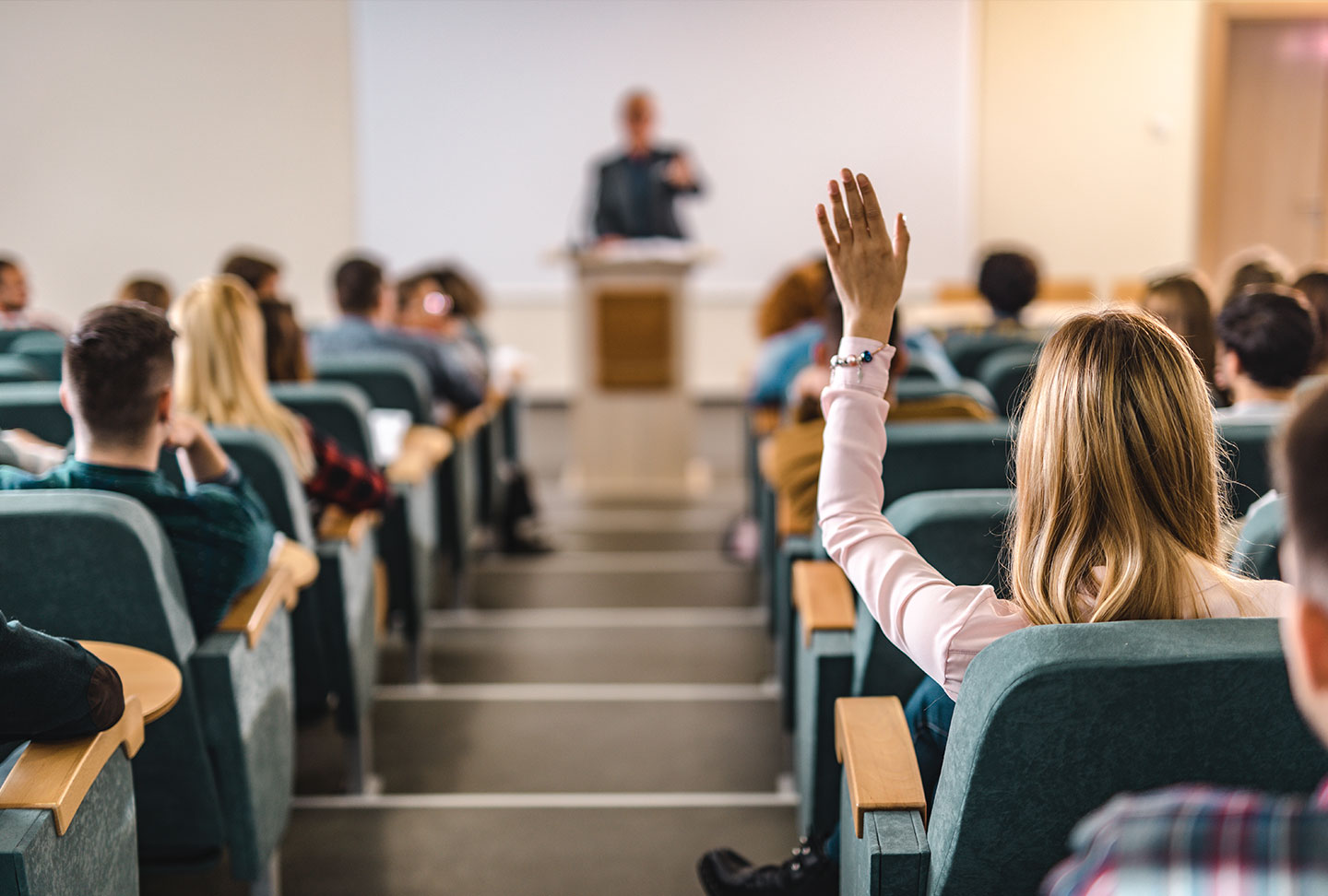 Female Teen Raising Handing During Lecture